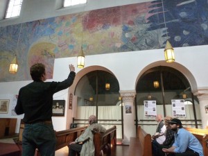 Associate Rector David explains the Pilgrims Progress mural at St Anselms