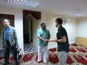 One of the Diamond Way Buddhists on the interfaith walk greets Daniel, who answered questions about the mosque